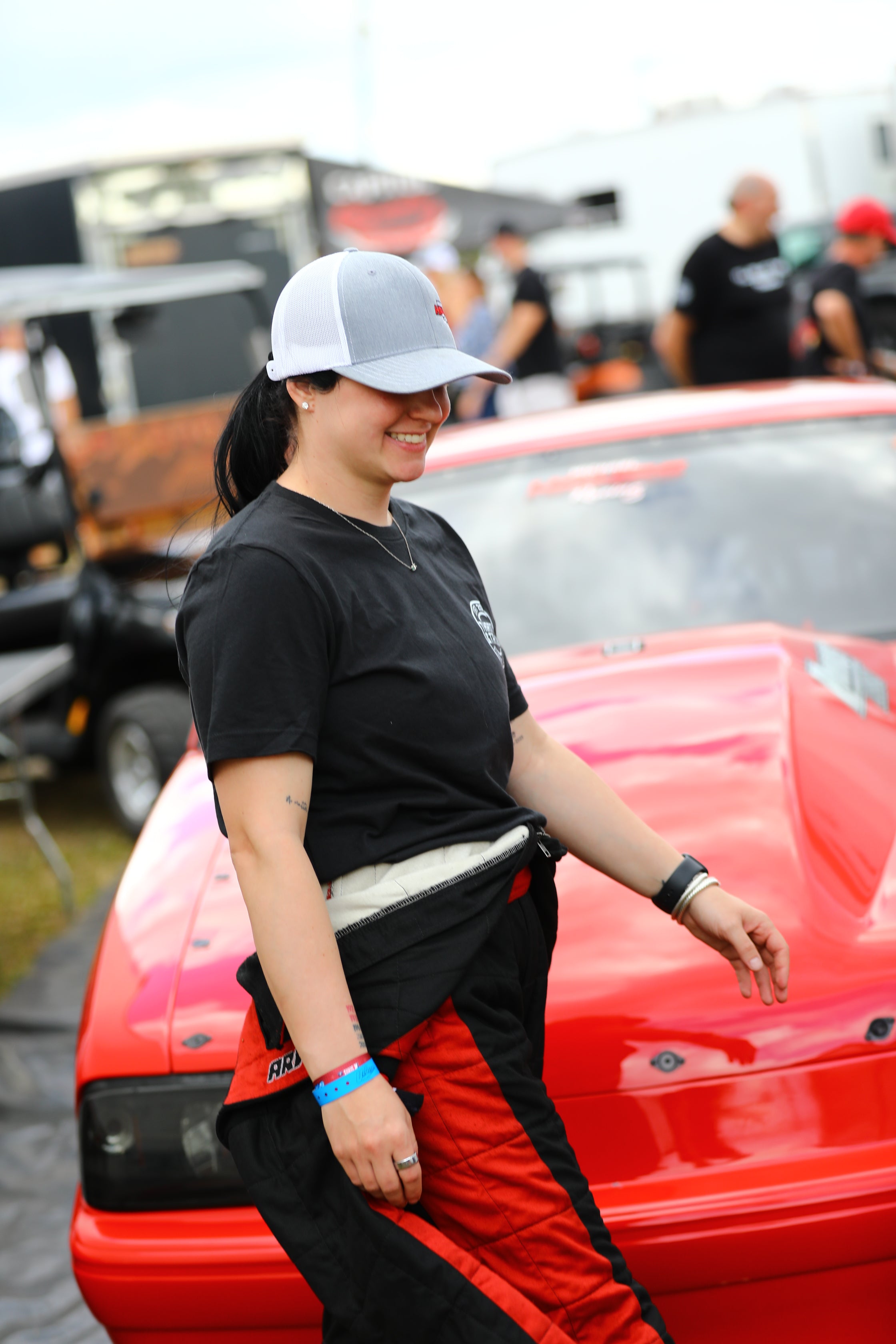 Person cleaning a red vehicle with a brush