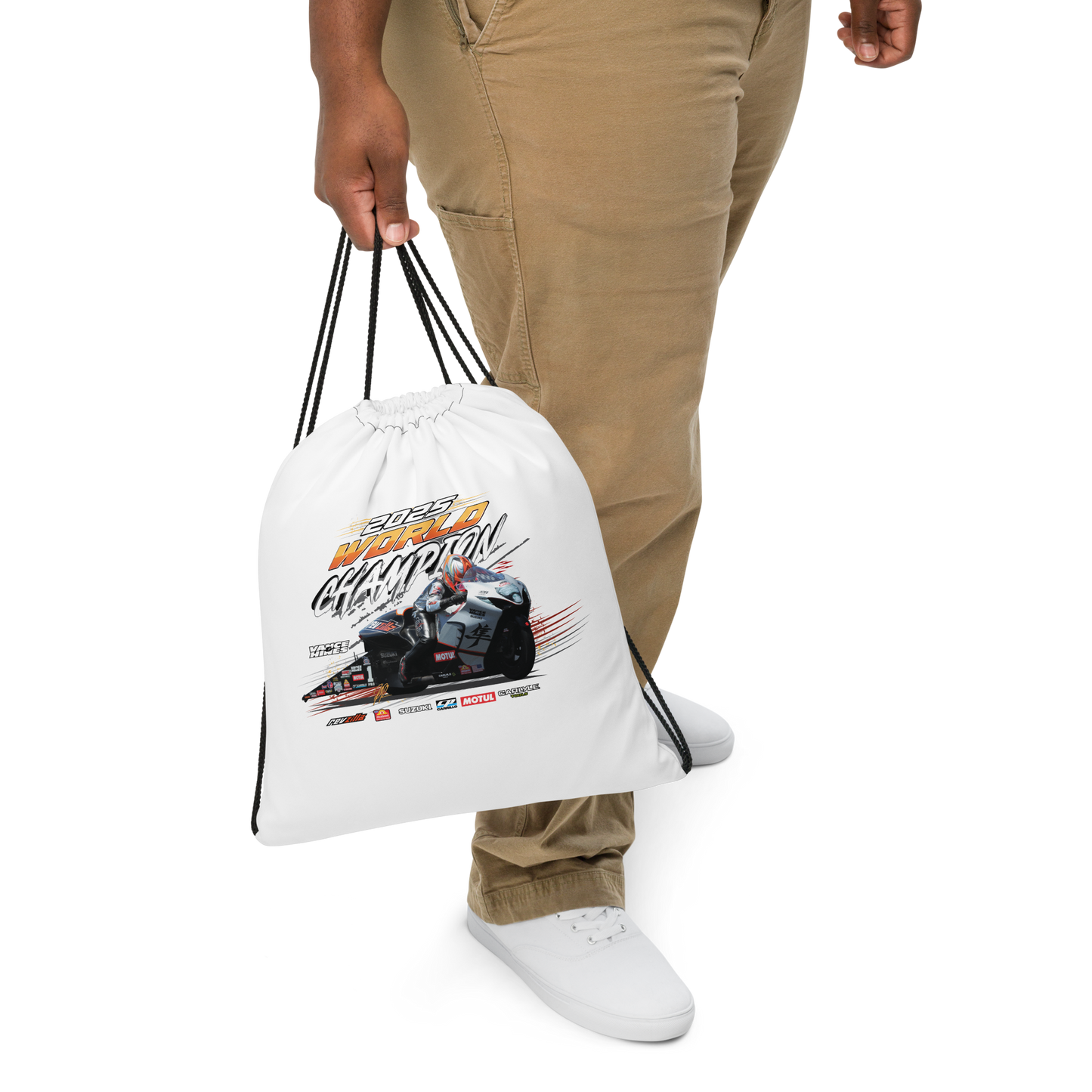 White drawstring bag held in hand, motorsport graphic on front