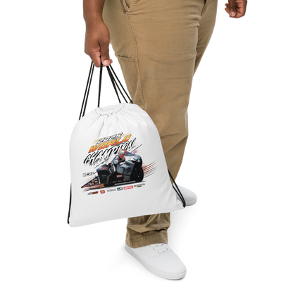 White drawstring bag held in hand, motorsport graphic on front